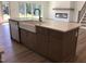 Kitchen island with white farm sink, granite countertop, and stainless dishwasher at 1404 Malcus Ct # 56, Fuquay Varina, NC 27526