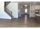 Open concept living room featuring wood floors, staircase, and entrance to kitchen at 1404 Malcus Ct # 56, Fuquay Varina, NC 27526