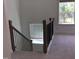 Carpeted staircase with dark wood banister, natural light and window at 1404 Malcus Ct # 56, Fuquay Varina, NC 27526