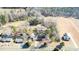 An aerial view shows the home nestled in a rural setting, surrounded by lush greenery and well-maintained lawns at 1413 Bud Hawkins Rd, Dunn, NC 28334