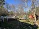 Expansive backyard featuring a deck with a hot tub and a trampoline at 1413 Bud Hawkins Rd, Dunn, NC 28334
