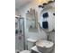 Contemporary bathroom featuring a walk-in shower, a round mirror, and updated fixtures at 1413 Bud Hawkins Rd, Dunn, NC 28334