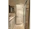 Bright bathroom features a single sink vanity, shower, and a white door at 1413 Bud Hawkins Rd, Dunn, NC 28334