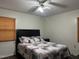 Bedroom with a ceiling fan, hardwood floors, and a comfortable bed and neutral-colored walls at 1413 Bud Hawkins Rd, Dunn, NC 28334