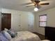 Cozy bedroom with multiple doors, a ceiling fan and a window with blinds for privacy at 1413 Bud Hawkins Rd, Dunn, NC 28334