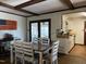 Open-concept dining room adjoining a galley kitchen with bright white walls at 1413 Bud Hawkins Rd, Dunn, NC 28334