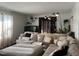 A cozy living room features a large sectional sofa, stylish decor, indoor plants, and plenty of natural light at 1413 Bud Hawkins Rd, Dunn, NC 28334