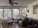 Bright sun room with large windows offering picturesque backyard views and ample seating at 1413 Bud Hawkins Rd, Dunn, NC 28334