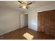 Comfortable bedroom featuring wood floors, a ceiling fan, and a double-door closet at 1516 Park Ln, Hillsborough, NC 27278