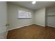 A bright bedroom features hardwood floors, a window with blinds, and a closet at 1516 Park Ln, Hillsborough, NC 27278