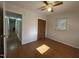 Bright bedroom with wood floors, ceiling fan, and spacious closet at 1516 Park Ln, Hillsborough, NC 27278