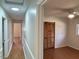 Hallway showcasing hardwood floors, white trim, and access to various rooms at 1516 Park Ln, Hillsborough, NC 27278
