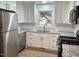 Well-lit kitchen features stainless steel appliances, granite countertops, and crisp white cabinetry at 1516 Park Ln, Hillsborough, NC 27278