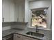 Kitchen sink with granite countertop and window overlooking backyard at 1516 Park Ln, Hillsborough, NC 27278