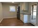 Bright laundry area with washer/dryer, cabinets, granite counters, and access to the exterior at 1516 Park Ln, Hillsborough, NC 27278