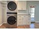 Laundry area with modern stacked washer/dryer and convenient storage space at 1516 Park Ln, Hillsborough, NC 27278