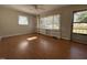 Living room features hardwood flooring and a large bright window with built-in shelving at 1516 Park Ln, Hillsborough, NC 27278