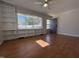 Open living room boasts built-in shelving and hardwood floors with a large window at 1516 Park Ln, Hillsborough, NC 27278