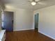 Living room features hardwood flooring, white trim, a grey door and panelled walls at 1516 Park Ln, Hillsborough, NC 27278