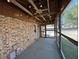 Enclosed sunroom with brick wall, carpet, ceiling fan, and windows overlooking the yard at 1516 Park Ln, Hillsborough, NC 27278