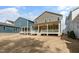 This backyard features a spacious, grassy area with well-maintained landscaping and covered porch at 1721 Birdhaven Ln, Wendell, NC 27591