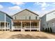 The back of this house has a large covered porch and a spacious backyard at 1721 Birdhaven Ln, Wendell, NC 27591