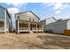 This backyard features a spacious, grassy area with well-maintained landscaping and covered porch at 1721 Birdhaven Ln, Wendell, NC 27591