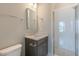 This bathroom features a single sink vanity with a stone countertop and a tiled walk-in shower at 1721 Birdhaven Ln, Wendell, NC 27591