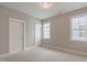 Bedroom featuring two windows and a five-panel door at 1721 Birdhaven Ln, Wendell, NC 27591