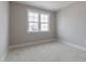 This bedroom is naturally lit by a window with white trim at 1721 Birdhaven Ln, Wendell, NC 27591