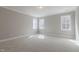 This bedroom is well-lit from three large trimmed windows at 1721 Birdhaven Ln, Wendell, NC 27591
