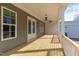 This spacious covered porch has wood flooring and a ceiling fan, perfect for outdoor entertaining at 1721 Birdhaven Ln, Wendell, NC 27591