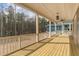 This covered porch features wood flooring and a view of the wooded area nearby at 1721 Birdhaven Ln, Wendell, NC 27591
