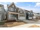 A gray two-story home features a covered porch and a two-car garage in a residential area at 1721 Birdhaven Ln, Wendell, NC 27591