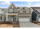 Charming two-story home features a covered porch, two-car garage, and welcoming curb appeal at 1721 Birdhaven Ln, Wendell, NC 27591