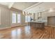 Open concept kitchen with hardwood floors, coffered ceilings, and view to outside doors at 1721 Birdhaven Ln, Wendell, NC 27591