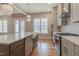 Bright kitchen featuring hardwood floors, a center island with a prep sink, and stainless appliances at 1721 Birdhaven Ln, Wendell, NC 27591
