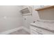 Laundry room featuring built in countertop and upper cabinets and tile flooring at 1721 Birdhaven Ln, Wendell, NC 27591