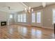 Spacious living room with hardwood floors, fireplace, and French doors to the outside at 1721 Birdhaven Ln, Wendell, NC 27591