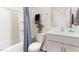 Bright bathroom featuring a shower with blue curtain, toilet, and vanity with modern fixtures and a white countertop at 1910 Frost Dr, Haw River, NC 27258