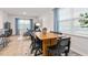 Inviting dining area with modern table and chairs, abundant natural light, and an open view to the living room at 1910 Frost Dr, Haw River, NC 27258