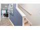Bright hallway with neutral tones and a modern art piece leading to a dining area with natural light at 1910 Frost Dr, Haw River, NC 27258