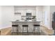 Modern kitchen island with granite countertops and seating for three, perfect for casual dining and entertaining at 1910 Frost Dr, Haw River, NC 27258
