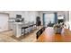 Open-concept kitchen featuring an island with seating, stainless steel appliances, and seamless flow to the dining and living areas at 1910 Frost Dr, Haw River, NC 27258