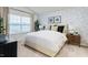 A serene main bedroom featuring a large window and a stylish accent wall at 1910 Frost Dr, Haw River, NC 27258