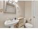 Cozy bathroom with sink, toilet and a small shelving cabinet at 200 S Dawson St # 103, Raleigh, NC 27601