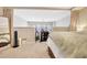 Spacious bedroom featuring neutral tones, a wooden dresser and a view of the living area at 200 S Dawson St # 103, Raleigh, NC 27601