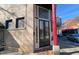 Charming exterior showcases brick facade, inviting entry, and vibrant red accents along a sidewalk at 200 S Dawson St # 103, Raleigh, NC 27601