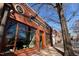Brick building facade featuring elegant signage and large storefront windows, showcasing a stylish presence at 200 S Dawson St # 103, Raleigh, NC 27601