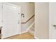 Inviting foyer with hardwood floors, a white front door, and a staircase leading to the upper level of the home at 200 S Dawson St # 103, Raleigh, NC 27601